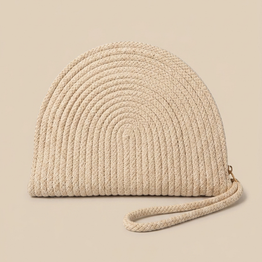 Beige woven handbag with a strap on a beige background