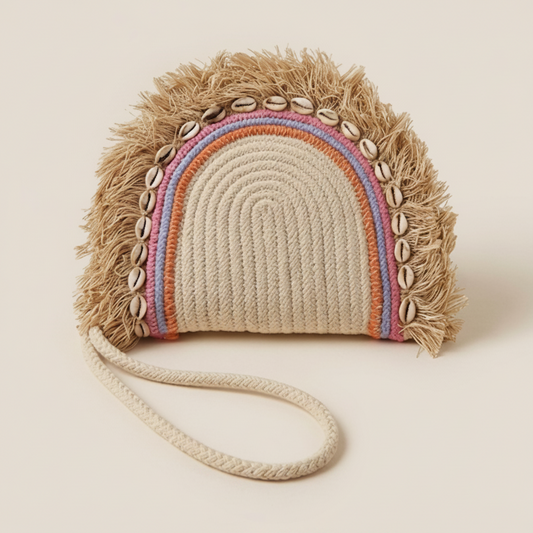 Handmade bag with rainbow pattern and shell embellishments on a beige background